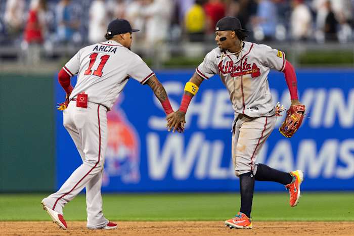 Jun 20, 2023; Philadelphia, Pennsylvania, USA; Atlanta Braves right fielder Ronald Acuna Jr. (13) and shortstop Orlando Arcia (11) celebrate a victory against the Philadelphia Phillies at Citizens Bank Park.